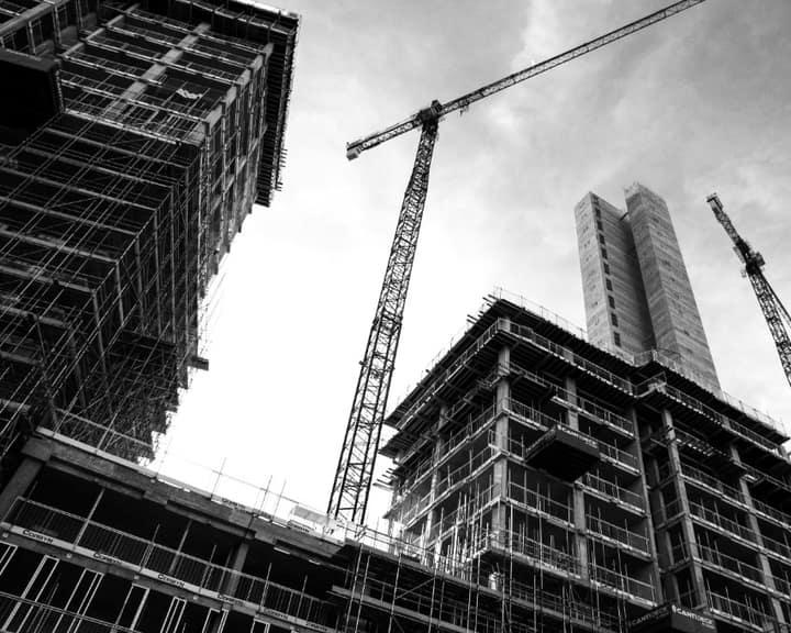 High-rise buildings under construction with tower cranes